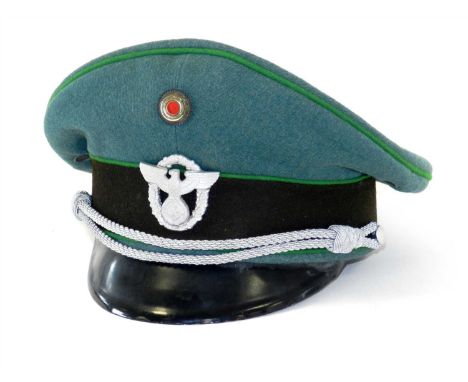 A German Third Reich Schutzpolizei Officer's visor cap, constructed of green gabardine wool with a brown woollen centreband a