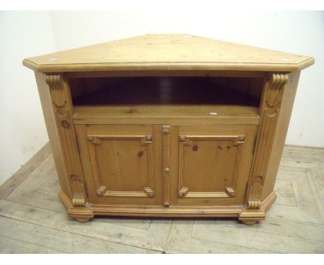 Large pine floor standing corner unit with open shelf above two carved panel cupboard doors (112cm x 57cm x 75cm)