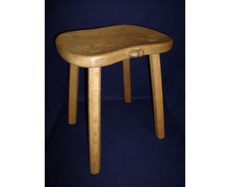 Carved oak Robert Thompson 'Mouseman' four legged milking style high seated stool with saddle shaped seat on four tapering oc