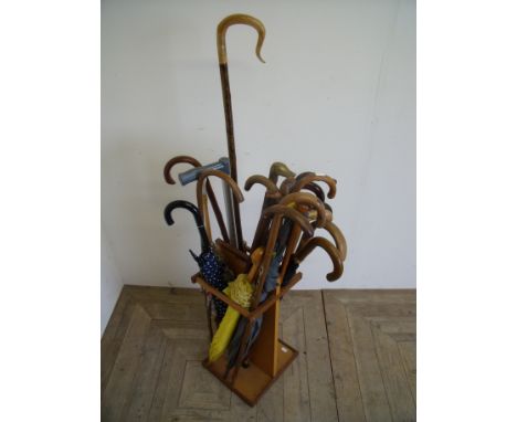 Sectional stick stand with a selection of various assorted walking sticks, umbrella etc including a rams horn shepherds crook