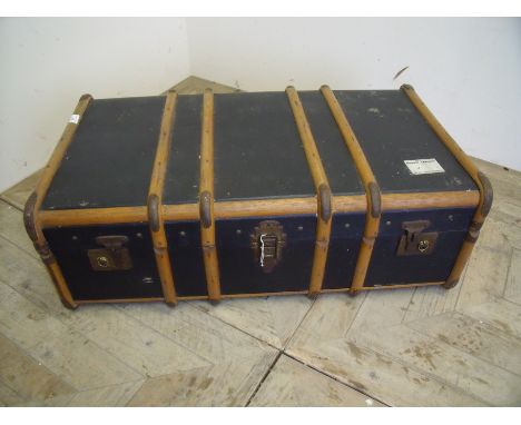 Wooden bound and blue canvas vintage travelling trunk