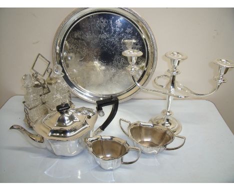 Box containing a selection of silver plate including three piece tea service, twin branch candelabra, circular tray and a fou