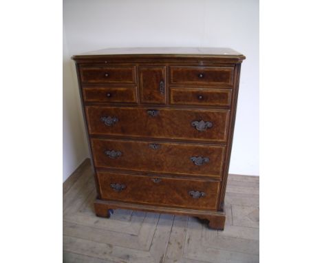 Cabinet in the form of a late 18th C walnut chest with the front lift up panel and full front in the form of multiple drawers