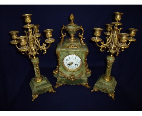 Victorian green onyx and gilt metal clock set with white enamel dial decorated with floral detail, the case crested with pine
