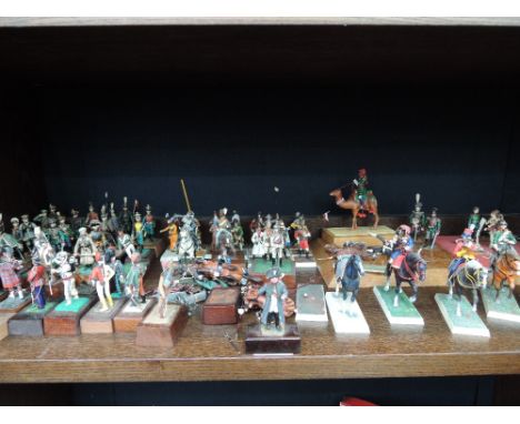 A shelf of cold cast and plastic military figures and animals