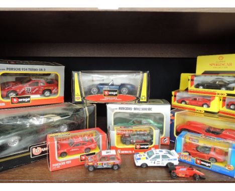 A shelf of mixed diecast cars including; Burago, Shell etc, most boxed