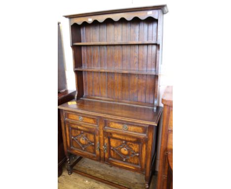 A 1920's oak open shelf back dresser with two drawers and two door cupboard on stand