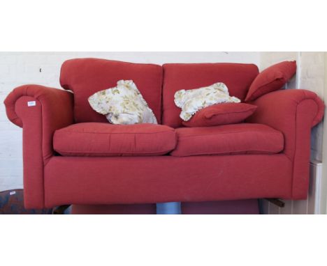A modern pale red upholstered sofa bed