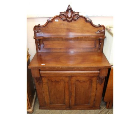 A Victorian mahogany chiffoniere with ornately carved shelf back