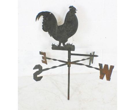 A vintage weather vane in the form of a cockerel