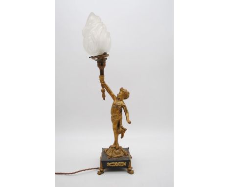 An ormolu lamp on marble base in the form of a putti holding aloft a torch - total height 56cm