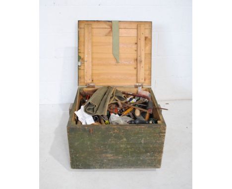A vintage trunk containing various tools including hammers, wrenches etc.