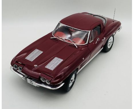 An unboxed Chevrolet Corvette Stingray (1:8 scale) plastic car model in maroon.