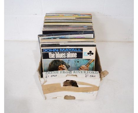 A quantity of 12" vinyl records including Eric Clapton, John Mayall, Oscar Peterson Trio, The Halliard, Seamus Tansey, Chubby
