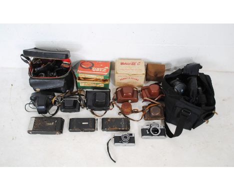 A collection of vintage cameras including Miranda Sensorex, Olympus OM10, Olympus Trip 35, Petri Flex V, Zenit E, Beirette, I