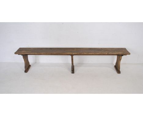A weathered wooden bench - length 221cm, height 45cm