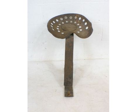 A vintage tractor seat and bracket