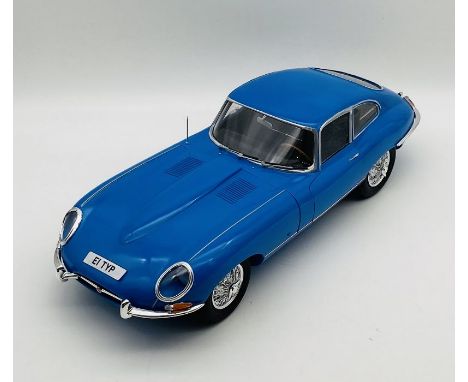 An unboxed Jaguar E-Type (1:8 scale) plastic car model in light blue