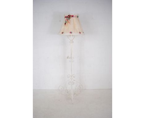 A white painted wrought iron standard lamp