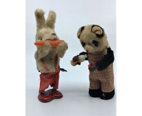 Two Automaton toys, c.1940's, to include a panda bear pouring and drinking milk and a rabbit eating a carrot, both in working