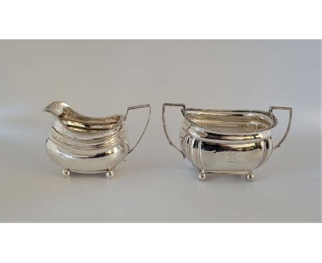 A silver two-handled sugar bowl,&nbsp;Sheffield 1912, engraved initial and dated "1913", with angular handles raised upon qua