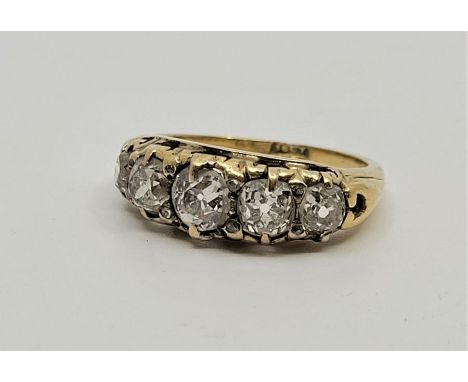 A late 19th century 18ct. gold five stone diamond ring, prong set five graduated old-cut diamonds above pierced gallery (ETDW