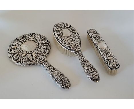 An Elizabeth II silver backed dressing table set, by W I Broadway &amp; Co, Birmingham 1961, comprising a hand mirror, hair a