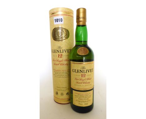 A bottle of The Glenlivet 12yr old Pure Single Malt Scotch Whisky "unhurried since 1824" with carton, older presentation labe