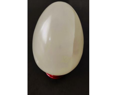 A light jade egg with stand, weight 317g.