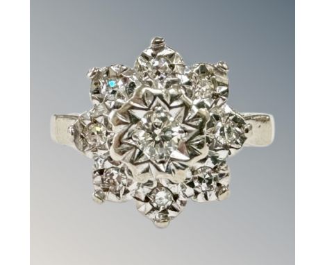 An 18ct white gold diamond cluster ring, size K, 4.3g. CONDITION REPORT: Central diamond surrounded by eight further diamonds