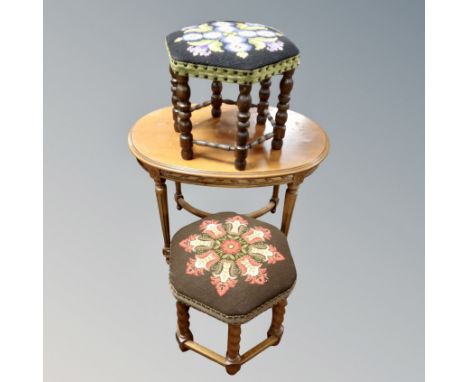 A oval beechwood occasional oval table together with two tapestry upholstered hexagonal foot stools.