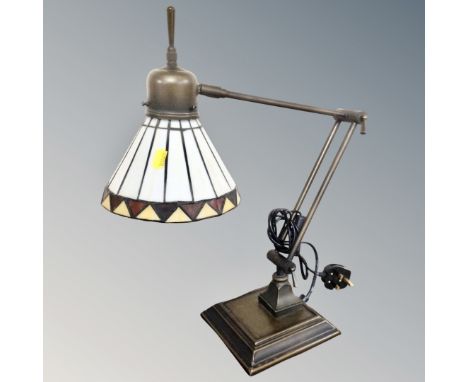 A contemporary angle poise desk lamp with leaded glass shade. 