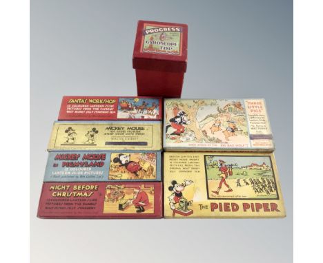 A group of boxed Disney lantern slides and a boxed Progress Gyroscope spinning top. 