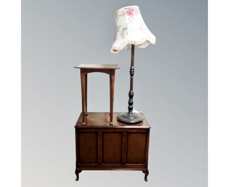 An Edwardian oak occasional table together with an oak panelled blanket box and a standard lamp with shade. 