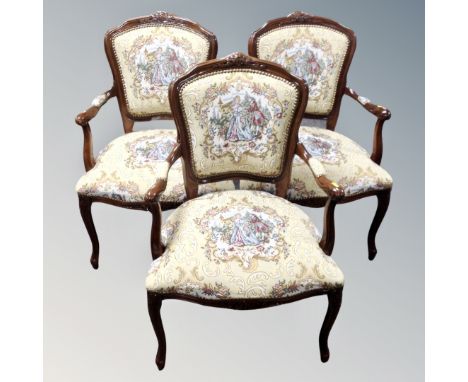 A set of three carved beech French style salon armchairs upholstered in a tapestry fabric. 