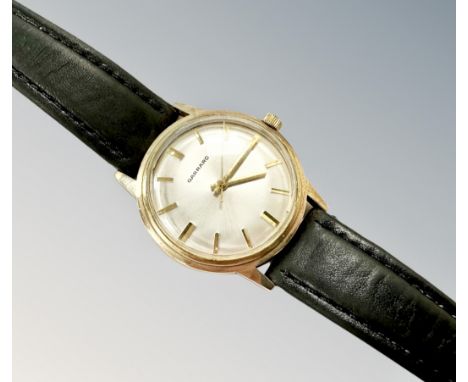 A gent's Garrard 9ct gold manual-wind wristwatch, silvered dial with baton markers and centre seconds, screw-off case back wi