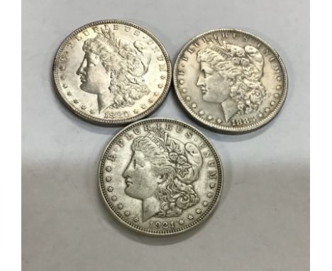 Three US Silver Morgan Dollars including 1880s, 1883o &amp; 1921D all weighing between 26.73g and 26.83g.