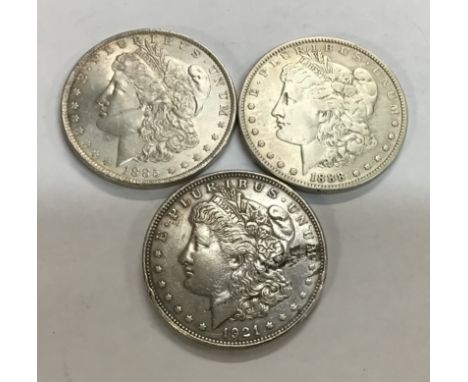 Three US Silver Morgan Dollars including 1885o, 1888o &amp; 1921 all weighing between 26.44 and 26.74.