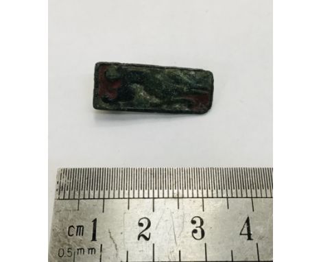                         This rectangular copper alloy Roman plate brooch features a hound in full chase on a blue and red ena