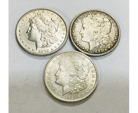 Three US Silver Morgan Dollars including 1879, 1884 &amp; 1921 all weighing between 26.41g and 26.83g.