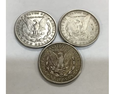 Three US Silver Morgan Dollars including 1880, 1882 &amp; 1921s all weighing between 26.73g and 26.83g.