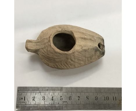                         Roman pottery oil lamp. It is 87 mm long by 53 mm wide. It is of the later more bulbous style and is 