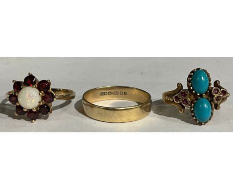 A Victorian style 9ct rose gold ring, set with a pair of polished oval turquoise cabochon, flanked by ruby chips, size N, Bir