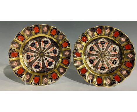 A pair of Royal Crown Derby 1128 Old Imari pattern shaped circular plates, solid gold band, 22cm diameter, first quality (2) 