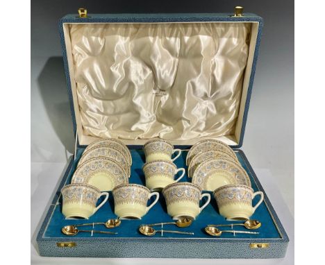 A set of six Royal Worcester Lady Evelyn pattern tea cups and saucers, the fitted case with six Art Deco silver gilt spoons, 
