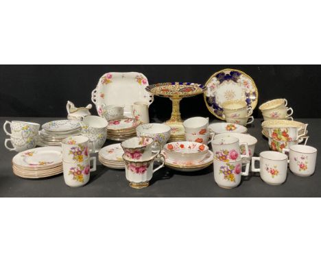 A Royal Worcester tea service for six, decorated with flowers, comprising cake plate, side plates, cream jug, sugar bowl, cup