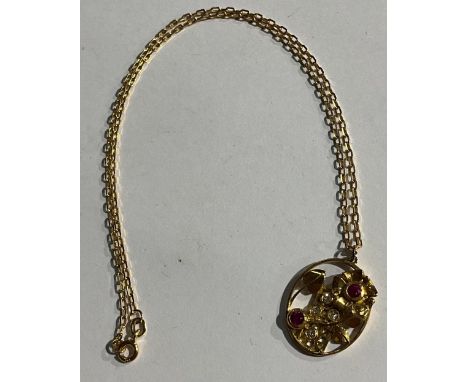 An unmarked gold openwork oval pendant, set with ruby and diamond stones, as flowers growing up a trellis, 2.5cm, suspended f