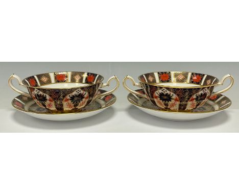 A pair Royal Crown Derby Imari palette 1128 pattern two handled soup dishes on stands, second quality, printed marks 