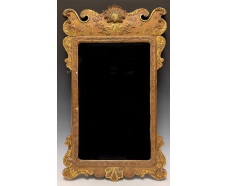 A George II Revival Vauxhall type parcel gilt looking glass, moulded shell crest over rectangular mirror plate, 74.5cm high 