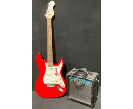 An Alba Fender Stratocaster type electric guitar, cherry red; a CD-G15 electric guitar amplifier, 18w (2) 
